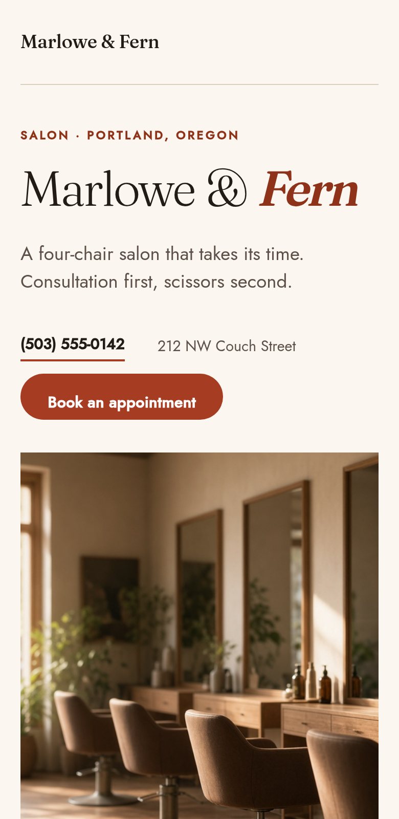 A salon site on a phone: the salon name, a one-line description, a phone number and a Book an appointment button above a photograph of the room.